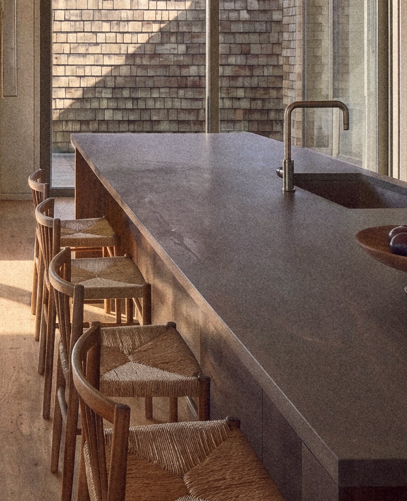 Rendering of woven rush stools at the kitchen island, the shingled courtyard wall beyond
